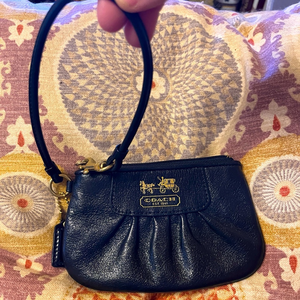 Very nice Coach wristlet coin purse. Excellent used condition. Interior purple